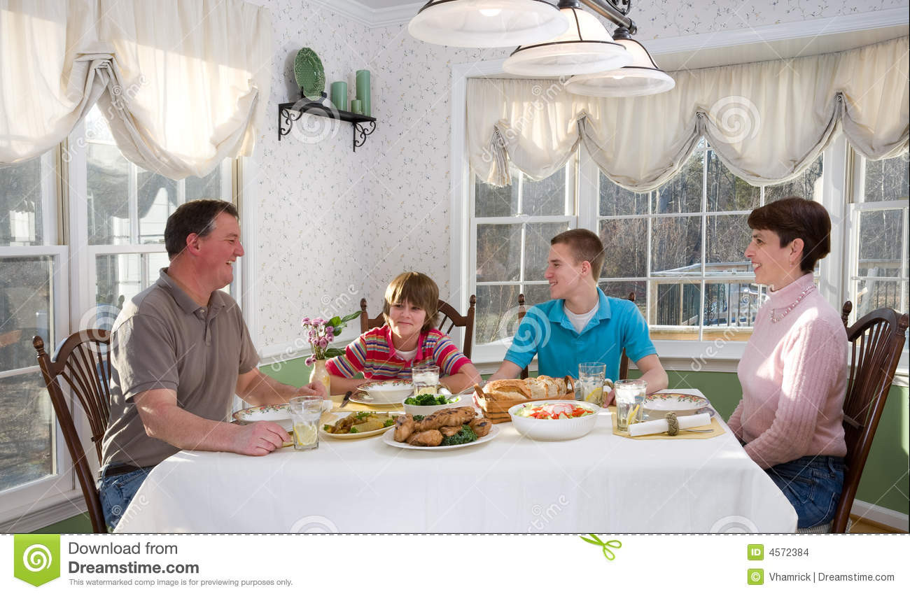The Dinner Table
 Happy Family Eating At Dinner Table Stock Image