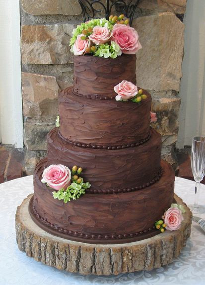 Chocolate Wedding Cake
 Four tier round chocolate wedding cake with pink roses JPG