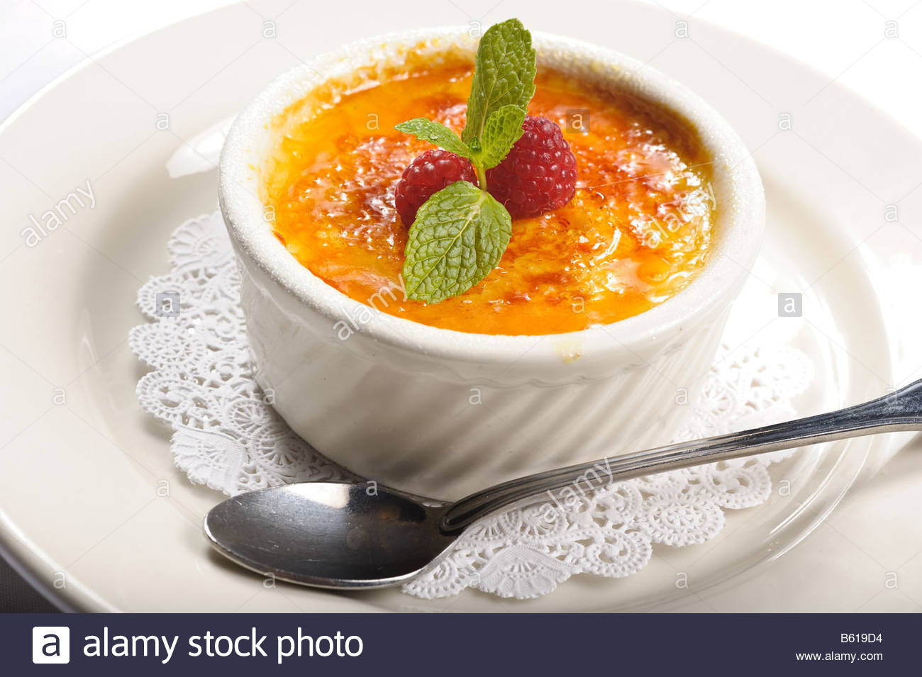 Creme Brulee Dessert
 Creme Brulee dessert in small dish on a plate with spoon
