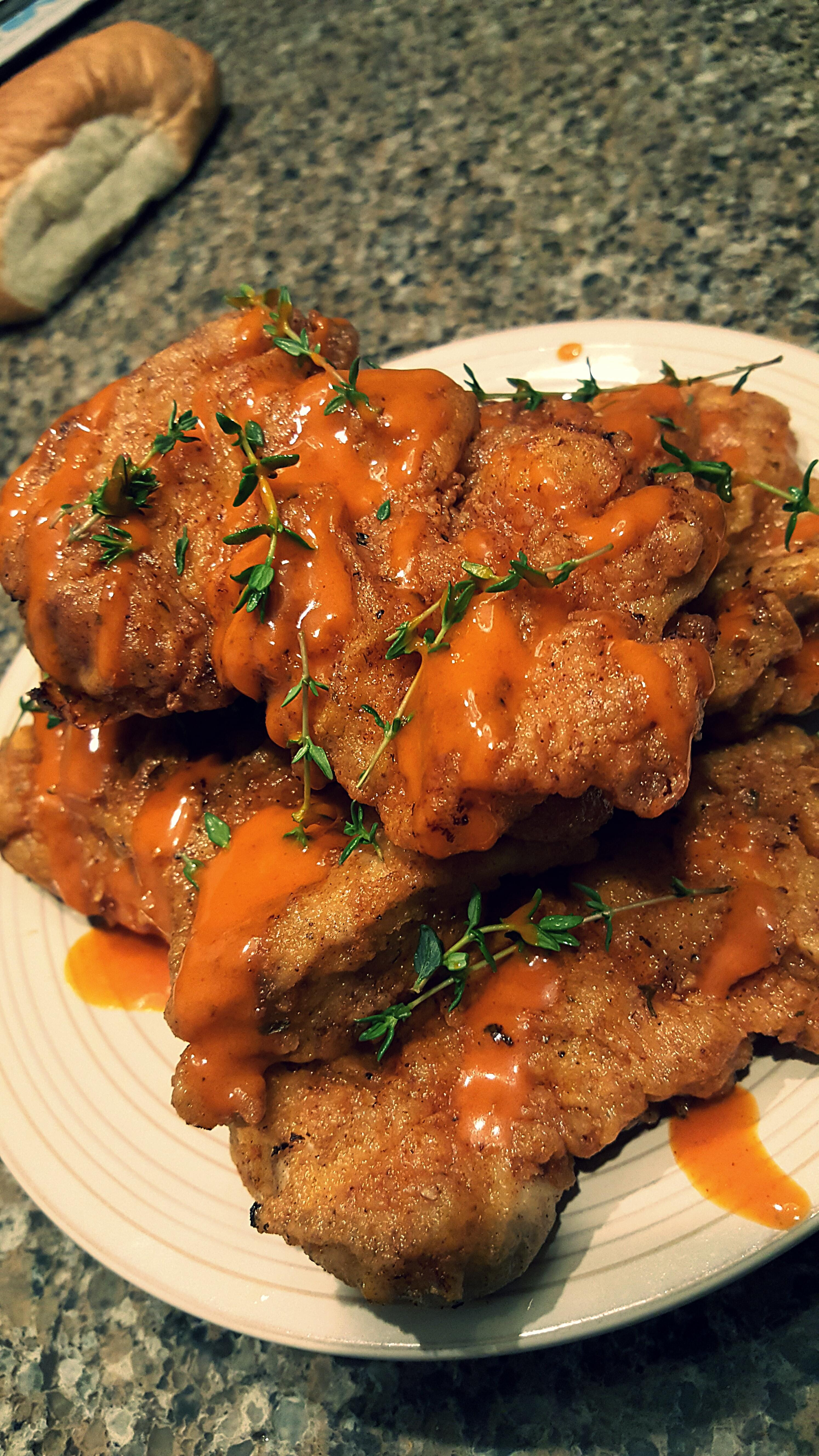 Deep Fried Chicken Thighs
 deep fried chicken thighs with hot sauce and thyme sprigs