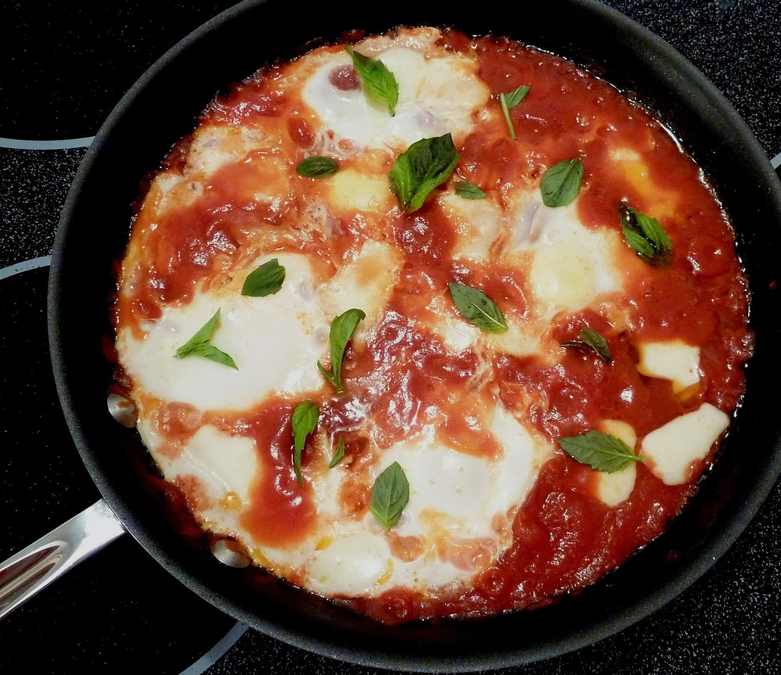 Eggs In Tomato Sauce
 Cracked Pepper Eggs in Tomato Sauce with Smoked Mozzarella