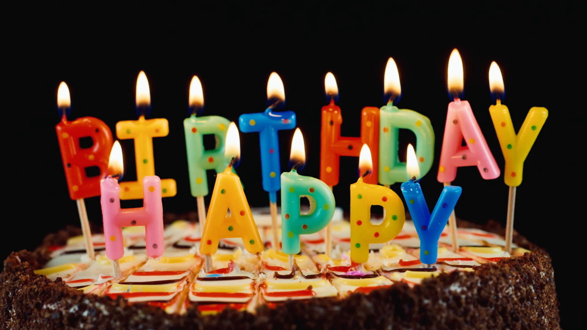 Happy Birthday Cake With Candles
 Festive candles HAPPY BIRTHDAY on a cake Stock Video