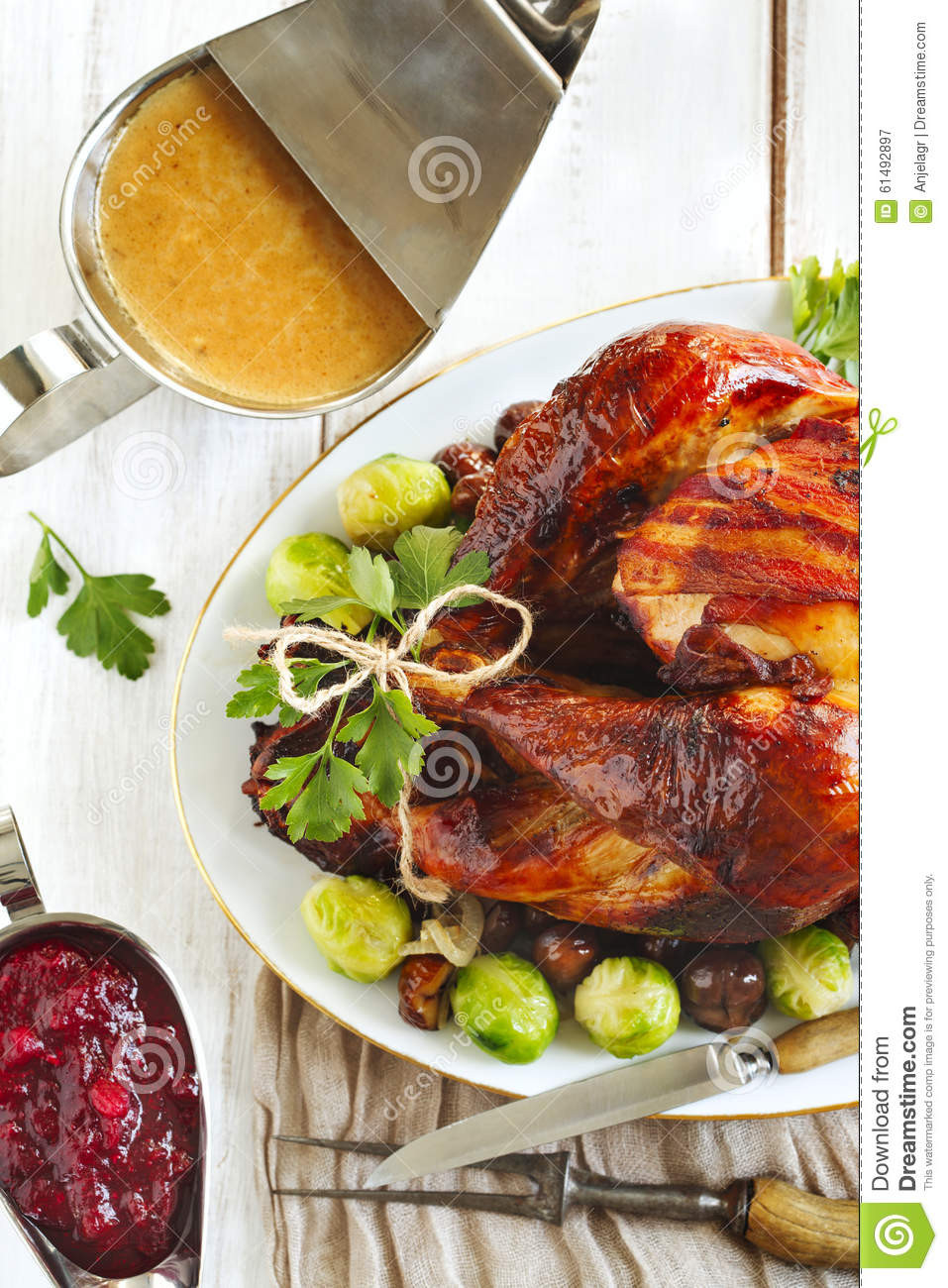 Prepared Turkey For Thanksgiving
 Roasted Turkey With Bacon And Garnished With Chestnuts And